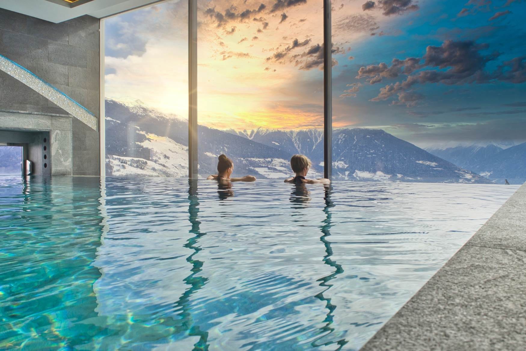 Two women in a pool and enjoying the views.