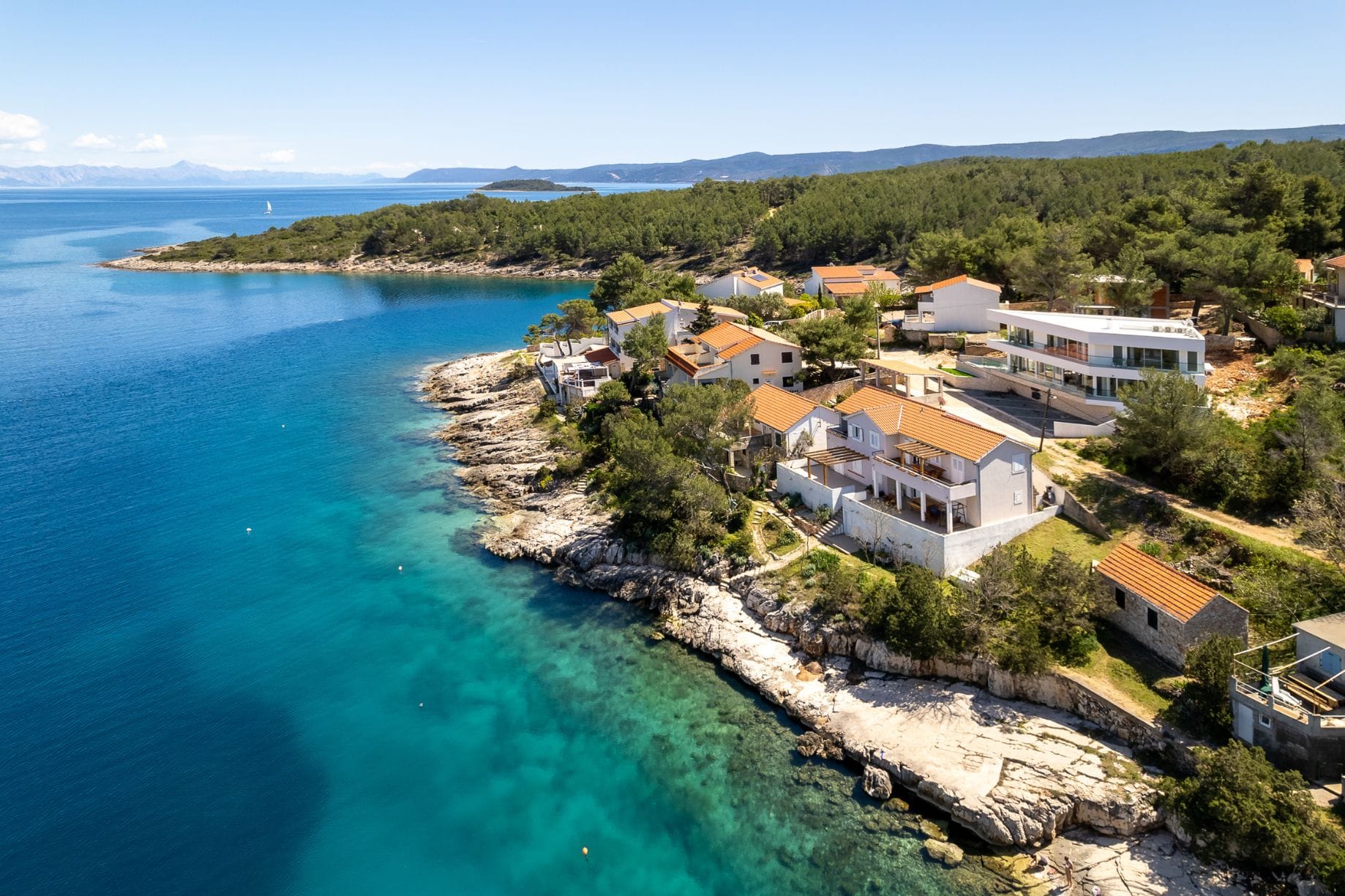 Houses by the shore with turquoise water in Croatia.