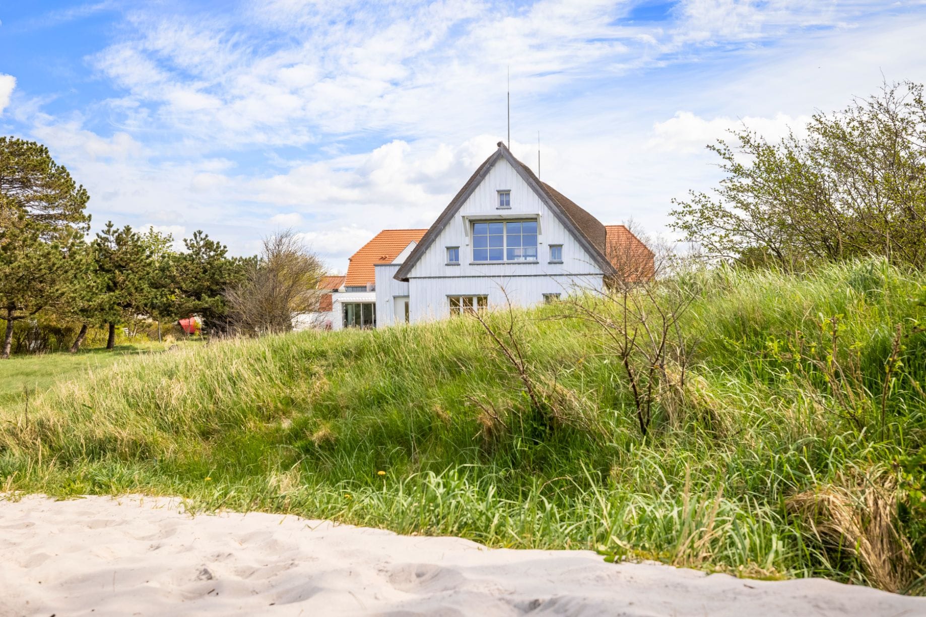 Traditional German house in the meadow and close to the dunes of the Baltic Sea.