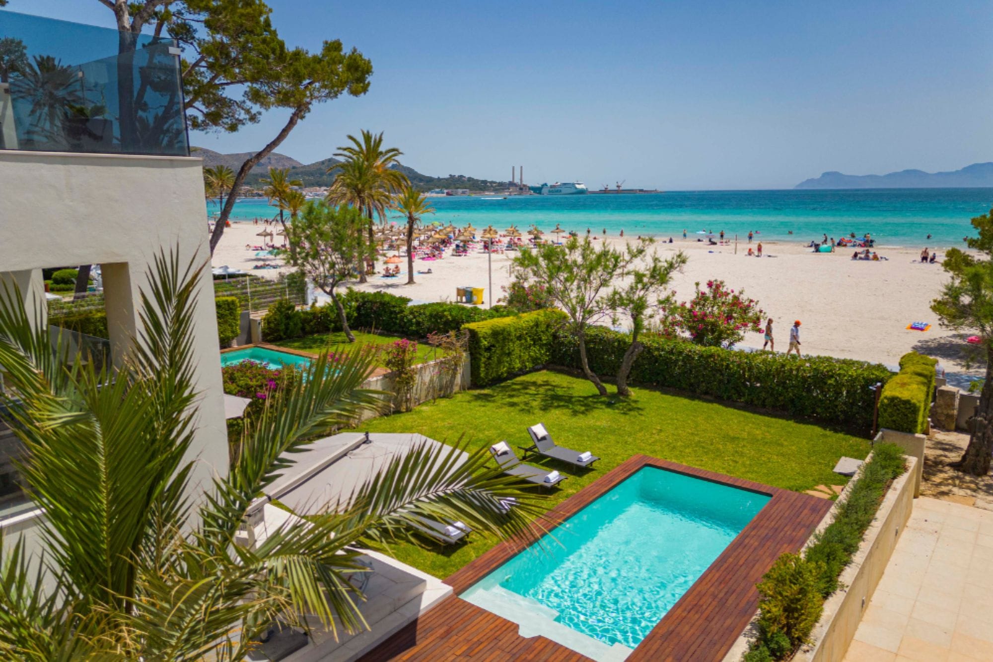 Modern apartment complex with pool by the beach.