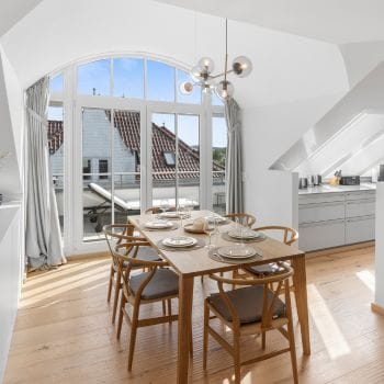 Modern dining room of a penthouse by the Baltic Sea.