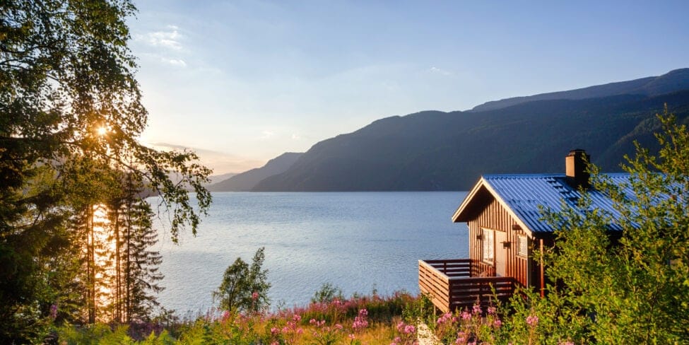 Swedish house by the water and mountains.